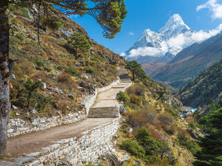 old stone road with steps and view to mount Ama-Dablam in Nepal