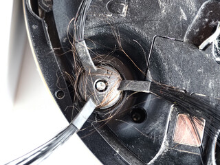 robot vacuum cleaner brush clogged with hair and dust