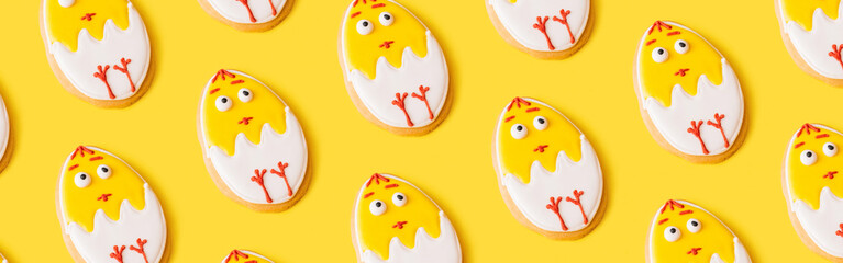 Banner made Pattern made of yellow easter cookies on yellow background. Easter concept. Top view, flat lay, copy space