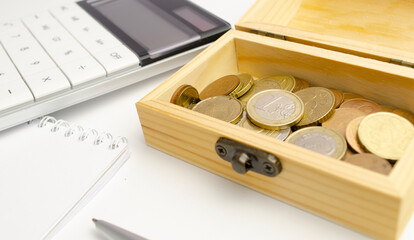 Close-up of bank statement, calculator, stack of coins and pen. Bank employee making report....