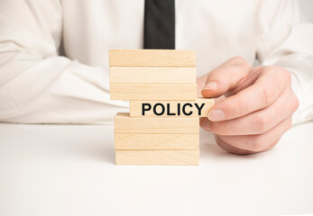 Policy word written on wood block. Policy text on wooden table for your desing, concept.