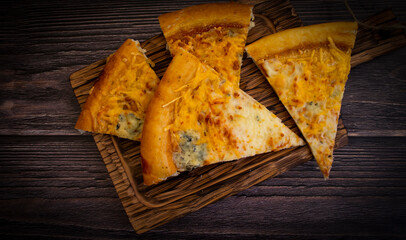 cheesy pizza on old wooden background