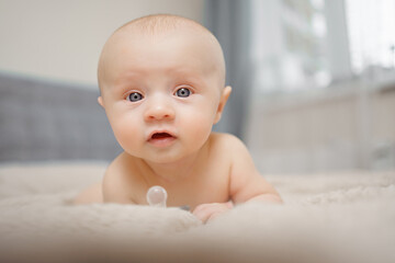 Funny and beautiful baby on the bed. children's health. 