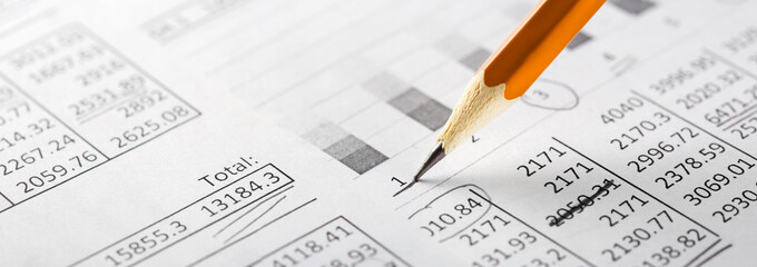 Accounting document with pencil and checking financial chart. Concept of banking, financial report and financial audit.