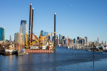 Jersey City, New Jersey, USA - December 22 2021: New York City downtown skyline. Financial district and World Trade Center. View from Jersey City dock.