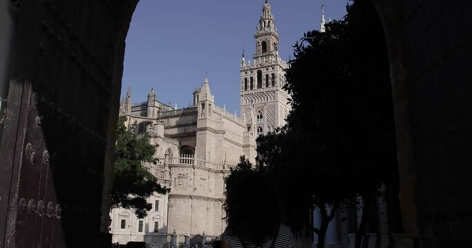 Woman sightseeing and exploring the city of Seville, Spain. Visiting the cathedral and the Giralda
