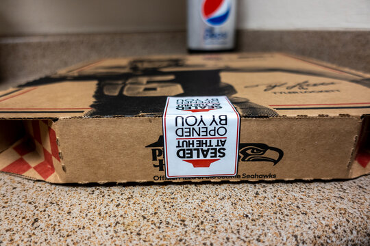 Seattle, WA USA - circa October 2021: Macro, selective focus on a Pizza Hut pizza box sitting on a kitchen counter after being delivered.