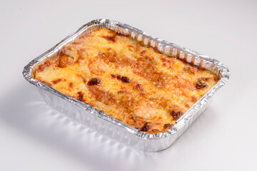 Lasagna delivery. Shrimp lasagna in packaging for delivery isolated on white background.