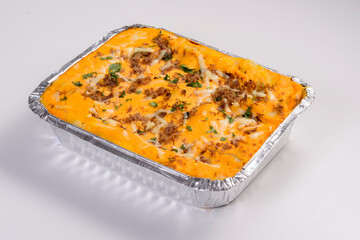 Lasagna delivery. Meat lasagna with cheddar in packaging for delivery isolated on white background.