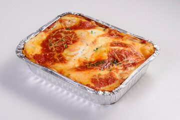 Lasagna delivery. Filet mignon lasagna in packaging for delivery isolated on white background.