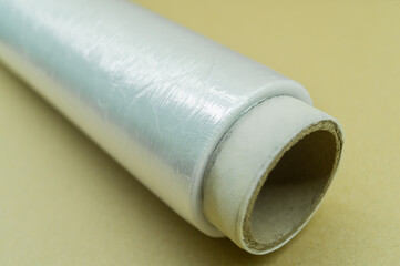 Roll of wrapping plastic stretch film. Packaging film in a roll on a cardboard spool. Selective focus
