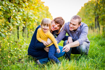 Portrait of happy family having fun together at a vineyard at sunny day