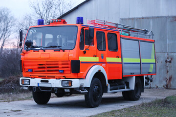 Red fire engine car parked with emergency ladder
