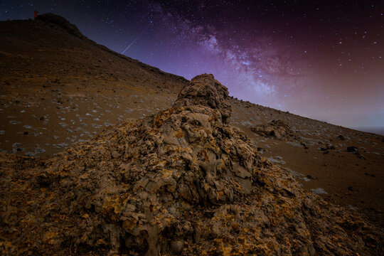 The rocky island of Bartolome, in the Galapagos, looks like another planet's landscape under a clear starry night.