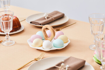 Close up of cute Easter eggs platter on elegant dinner table decorated for Spring, copy space