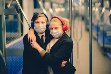 Obraz premium Children with face mask going back to school after covid-19 quarantine and lockdown.