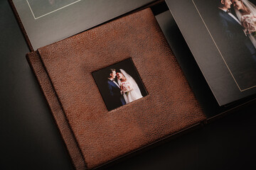 wedding photobooks in brown leather binding with photos on the cover