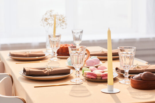 Background image of elegant dinner table decorated for Easter in soft and airy tones, copy space