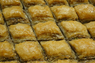 Delicious traditional Turkish Baklava dessert arranged in rows close-up macro full frame pattern