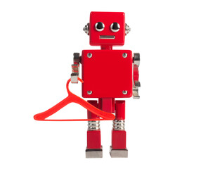 Isolated photo of red colored metal miniature robot toy standing with clothes hanger on white background.