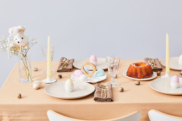Minimal background image of elegant dinner table decorated for Spring and Easter, copy space