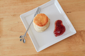 Scones with Strawberry Jam on white plate, Traditional English afternoon tea. copy space for text,...
