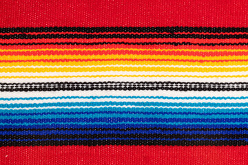 Traditional Colorful Mexican serape fabric, full background. Hand woven Latino blanket with...