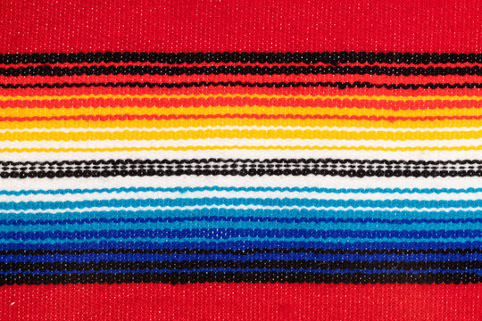 Traditional Colorful Mexican serape fabric, full background. Hand woven Latino blanket with specific vibrant colors.