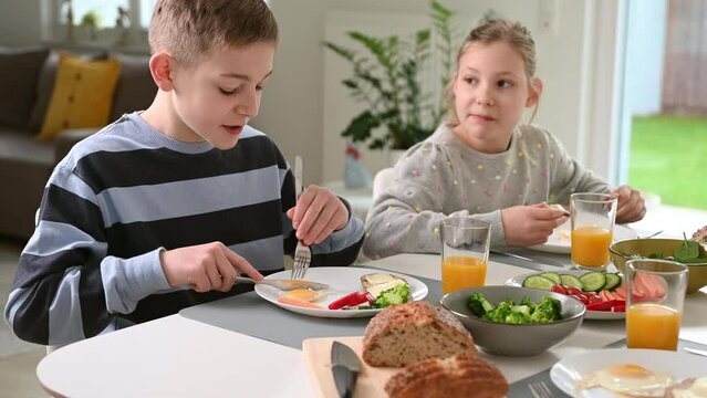 Teen children having healthy breakfast at home in the morning