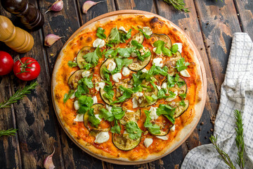 pizza with eggplant and cheese on old wooden table top view