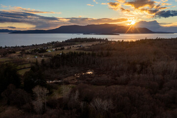 Sunset Over Orcas Island, Washington. Located in the San Juan Islands this drone view and dramatic...