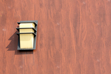 wall lamp installed on a wooden molding wall