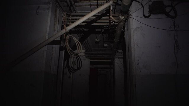 Scary dark underground deserted bunker walking with flashlight dangerous