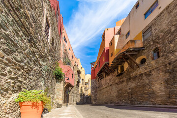 Scenic cobbled streets and traditional colorful colonial architecture in Guanajuato historic city center.