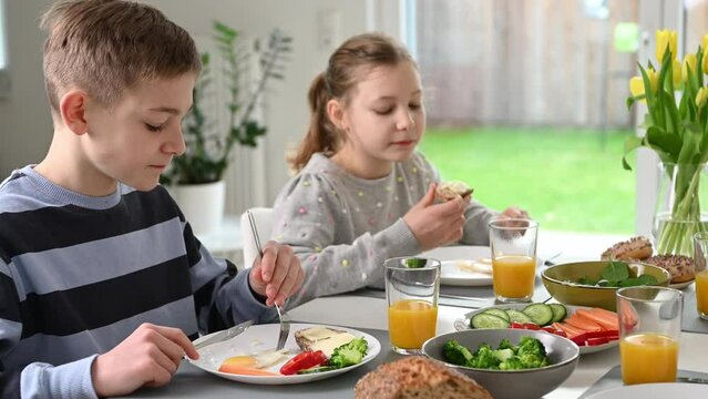 Teen children having healthy breakfast at home in the morning