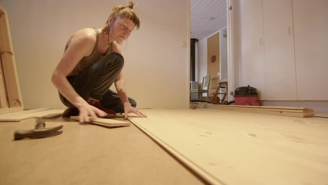 AUTHENTIC, DIY, LOW ANGLE - a new wooden floor being laid