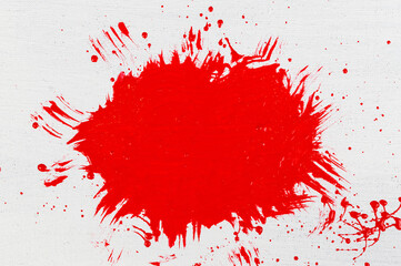 thick red acrylic paint applied in an uneven patch on a flat surface