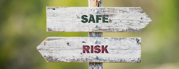 opposite signs on wooden signpost with the text quote safe risk engraved. Web banner format. - obrazy, fototapety, plakaty