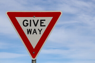 give way sign against blue sky