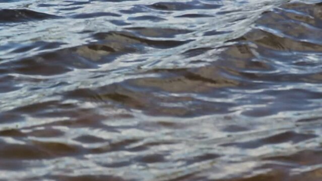Reservoir waves closeup sloshing on an overcast day water surface background
