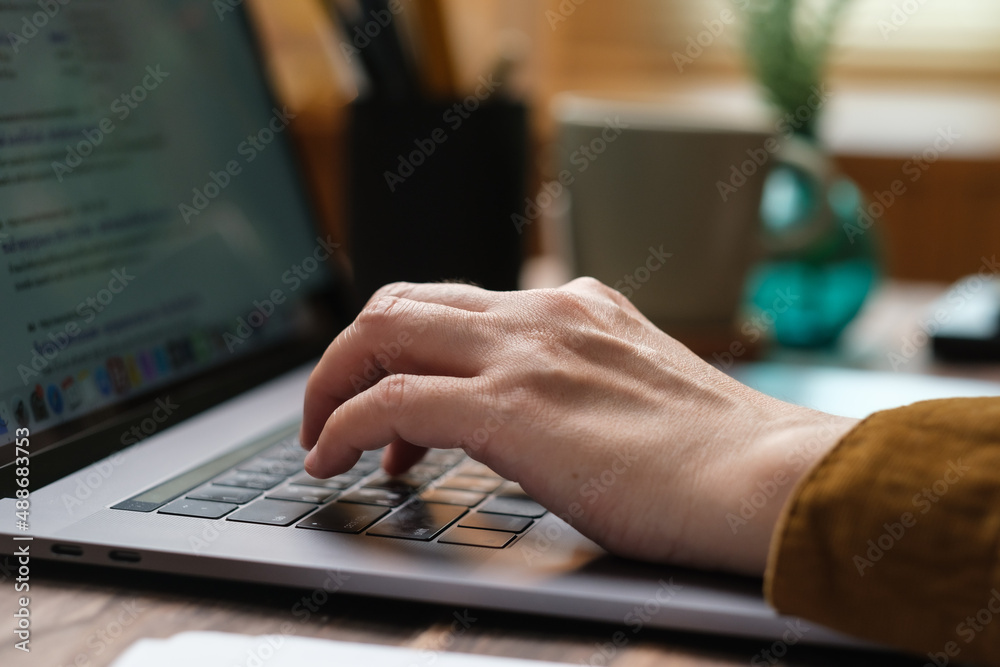 Poster close up hand typing on laptop keyboard when woking at home
