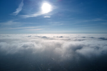 Aerial view from high altitude of earth covered with puffy rainy clouds forming before rainstorm