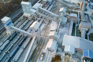 Aerial view of cargo train loaded with crushed sandstone materials at mine factory. Railway...