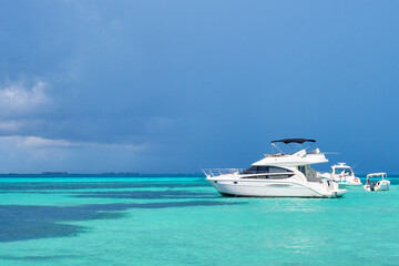 yacht in north beach of isla mujeres, Cancun, Mexico.Blue sky with rain nearby and turquoise blue...