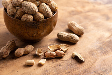 A Bowl of In Shell Peanut on a Wooden Table