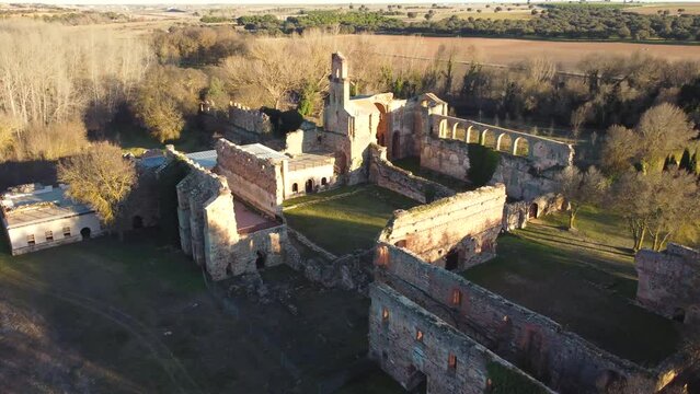Rotating aerial view of ruined stone monastery in Moreruela, Zamora, Spain. XII-XIII century buiding of the christian monastic cluny order. Camera getting close.