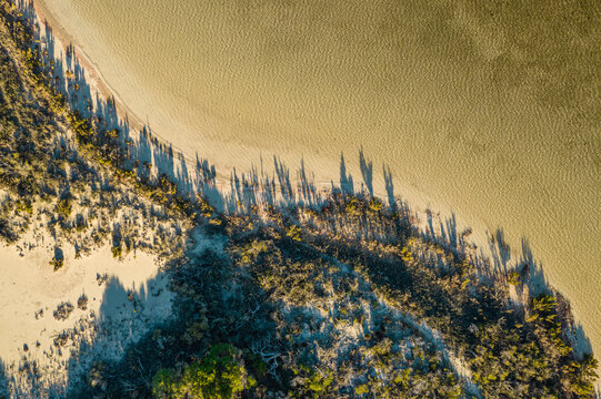 Late afternoon shadows cast along the shoreline of a salt lake near in Beekeepers National Park Jurien Bay