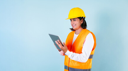 Hispanic woman Professional engineering and worker holding digital tablet with helmet in Mexico Latin America
