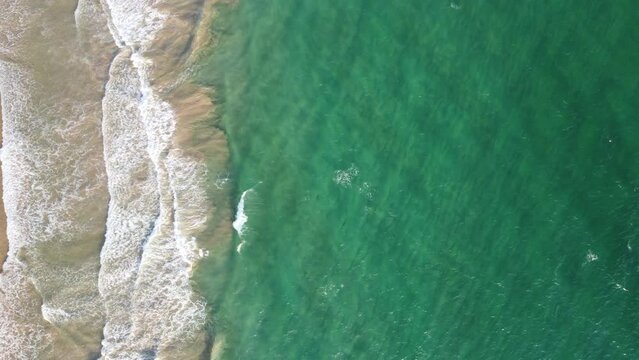 Aerial view of an emerald green sea and big foaming waves. Indian Ocean. Dikwella beach. Sri Lanka. High quality photo