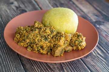 Nigerian Egusi Melon soup with garri eba for lunch